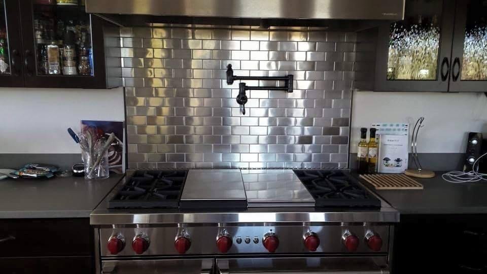 Modern kitchen with stainless steel appliances and backsplash