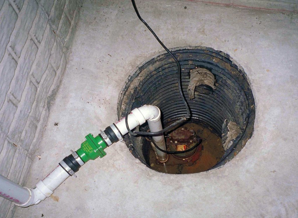 Sump pump installation in a basement well