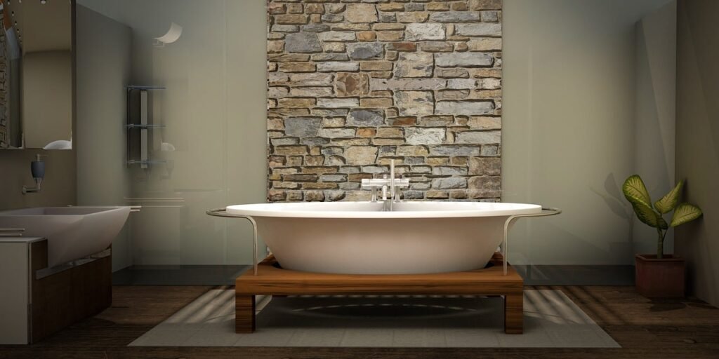 Elegant bathroom with freestanding tub and stone wall