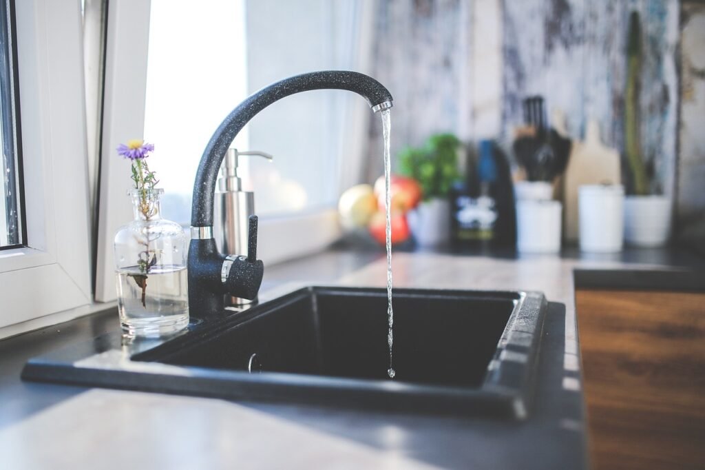 Modern kitchen sink with running water