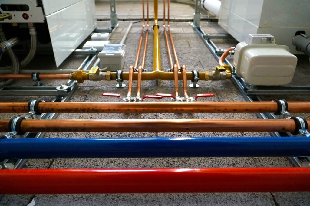 Colorful industrial pipes installed on floor