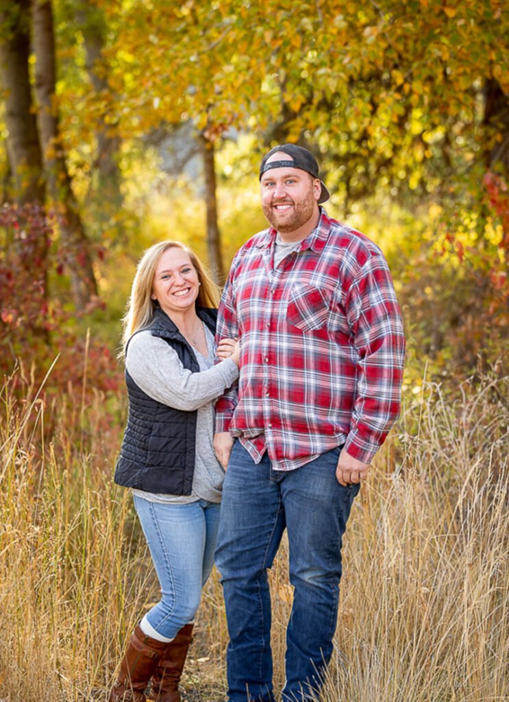 Couple posing in autumnal forest setting